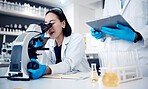 Microscope, scientist and woman with worker, research and medical cure in laboratory. Clipboard, researchers and employees analyzing results, innovation or check sample data for collaboration or talk