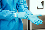 Healthcare, scrubs and surgeon hands with gloves for protection in surgery, medical operation and procedure. Safety, doctor and medical worker with latex ppe in clinic, hospital and operating room
