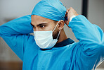 Head, doctor and prepare with mask for surgery in an operating room in a medical hospital. Surgeon, clinc and healthcare professional ready to operate while apply face mask and preparing