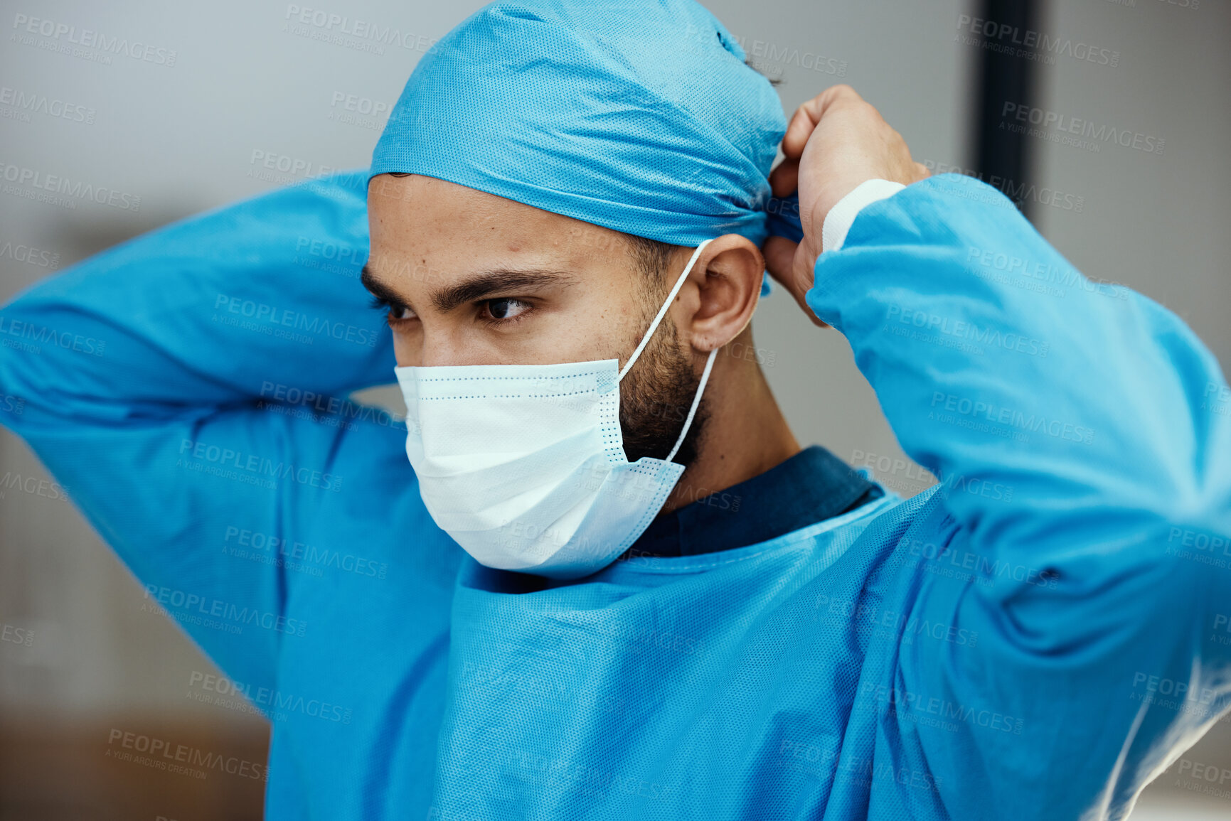 Buy stock photo Head, doctor and prepare with mask for surgery in an operating room in a medical hospital. Surgeon, clinc and healthcare professional ready to operate while apply face mask and preparing