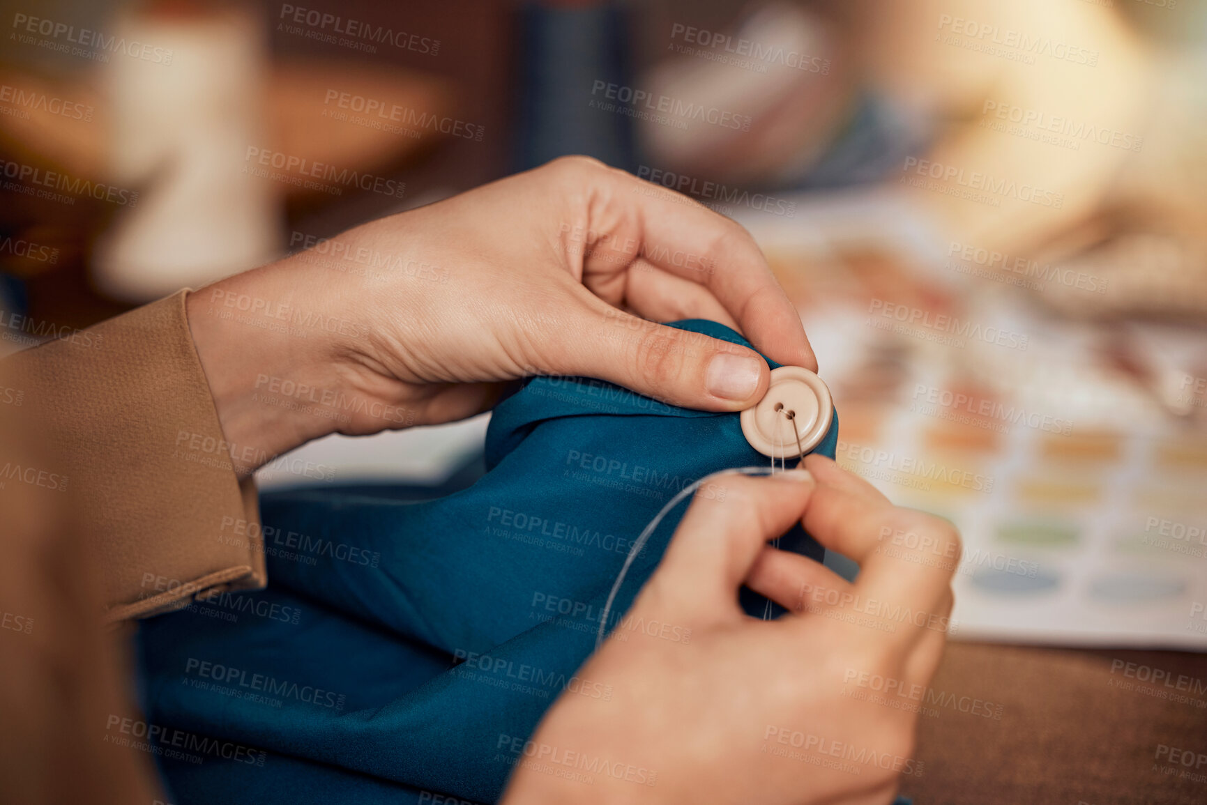 Buy stock photo Womab, hands and sewing clothes button in studio for designer wear, fashion garment and creative fabric design. Tailor, boutique startup and fashion designer hand or seamstress working on clothing 