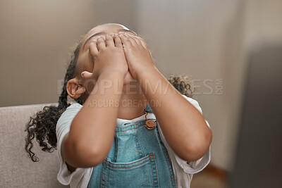 Buy stock photo Child, hands on face and covering eyes for hide and seek game at home while playing for fun, entertainment and fun activity. Cute girl kid on house chair while hiding, playful and doing peekaboo