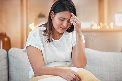 Woman, stress and headache in pain on sofa from depression, anxiety or mental health issues at home. Sad female holding head suffering from mental illness, discomfort or loss on living room couch