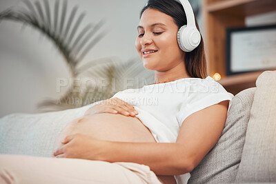 Buy stock photo Pregnant woman, relax and listening to calm music on sofa in healthy zen, wellness or meditation at home. Happy pregnant female in relaxation relief holding tummy with headphones on living room couch