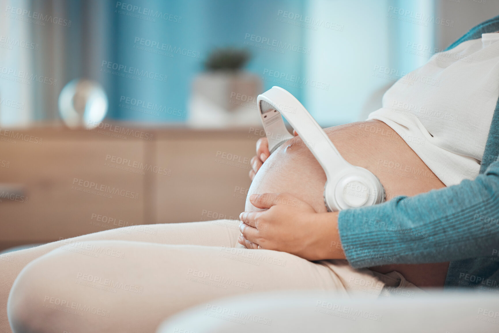 Buy stock photo Relax music, pregnant and stomach of a woman on the sofa for peace, calm and sound for baby during pregnancy. Radio love, streaming and mother with audio therapy with headphones for child on tummy