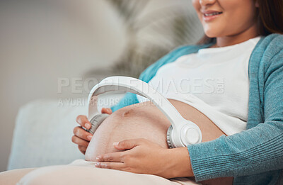 Buy stock photo Pregnant woman, headphones and listening to music or podcast for zen, calm and peace with hands on stomach for kick and moving. Female with wireless audio to relax and connect during pregnancy