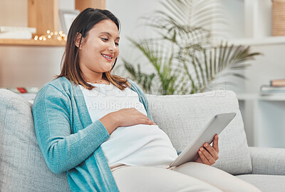 Buy stock photo Streaming movies, pregnant woman and tablet watching videos and scrolling on social media while relax on the couch alone in home. Happy, smiling or casual female watch pregnancy video online in house