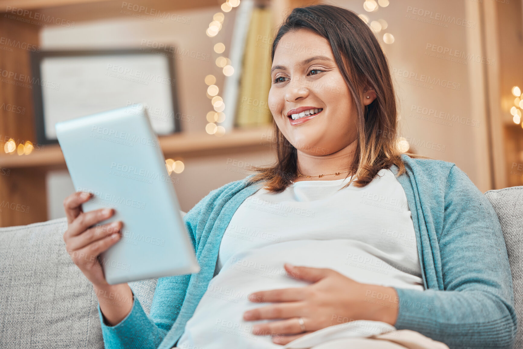 Buy stock photo Relax, pregnancy and woman on sofa with tablet in living room at home reading email or ebook. Internet, video call or social media, happy pregnant woman sitting on couch with smile surfing online.