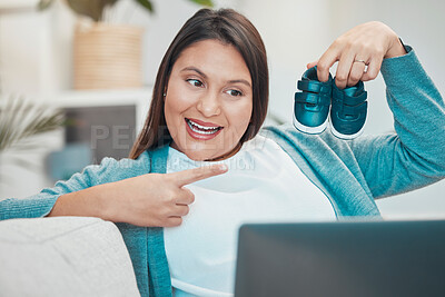 Buy stock photo Video call, laptop and baby shoes with a mother making an online announcement about pregnancy. Pregnant, footwear and video conference on the internet with a woman excited about being a parent