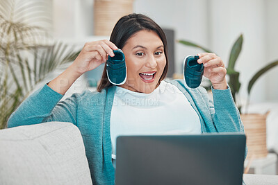 Buy stock photo Laptop, baby shoes and video call with a pregnant woman showing infant footwear during virtual communication. Computer, mother and excited with a female parent holding newborn booties in her home