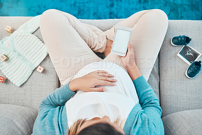 Buy stock photo Woman, pregnant and phone screen, branding and mockup space for advertising, social media and relax on sofa with toys, above and baby cloths in home. Mother, 5g smartphone and reading online post