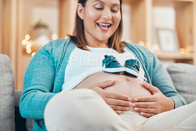 Buy stock photo Mother, pregnancy and pregnant stomach in hands, woman with shoes for baby, excited about childbirth and happy at family home. Happiness, mama and love, prenatal health and wellness with maternity.