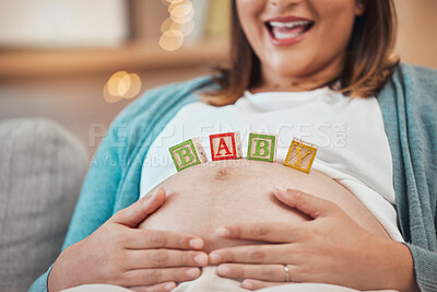 Buy stock photo Woman, hands or pregnant stomach with baby building blocks, toys or wooden object in house or family home living room. Zoom, pregnancy or mother touching belly on sofa for child development or growth