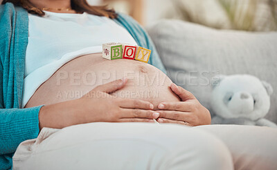 Buy stock photo Mother, stomach and toys with a boy baby for expecting mother relaxing at home on the sofa. Child, announcement and pregnancy notification with a woman with wood blocks on her belly for a son