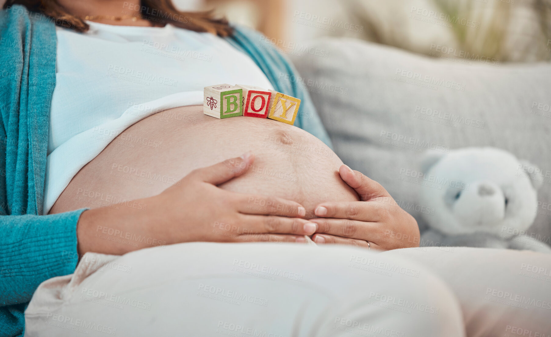 Buy stock photo Mother, stomach and toys with a boy baby for expecting mother relaxing at home on the sofa. Child, announcement and pregnancy notification with a woman with wood blocks on her belly for a son