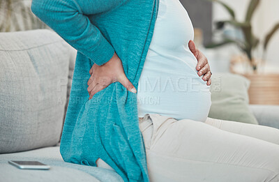 Buy stock photo Back pain, pregnancy and woman relaxing on a sofa in her living room at her modern house. Medical emergency, injury and pregnant lady with a swollen body, physical inflammation and backache at home.