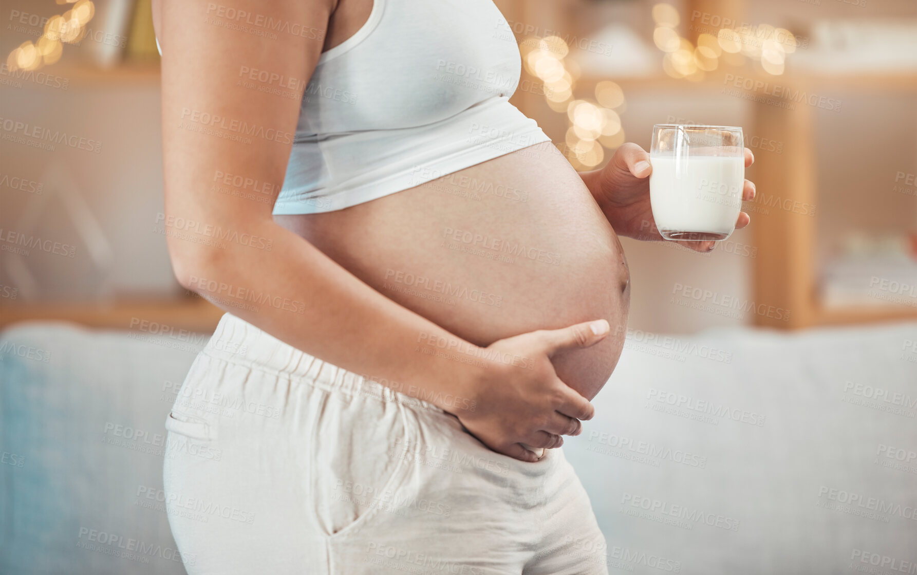 Buy stock photo Woman, pregnant stomach and glass of milk for nutrition, wellness or healthy diet of future baby. Pregnancy, abdomen and lady drinking dairy for body care, maternity and vitamins, protein and calcium