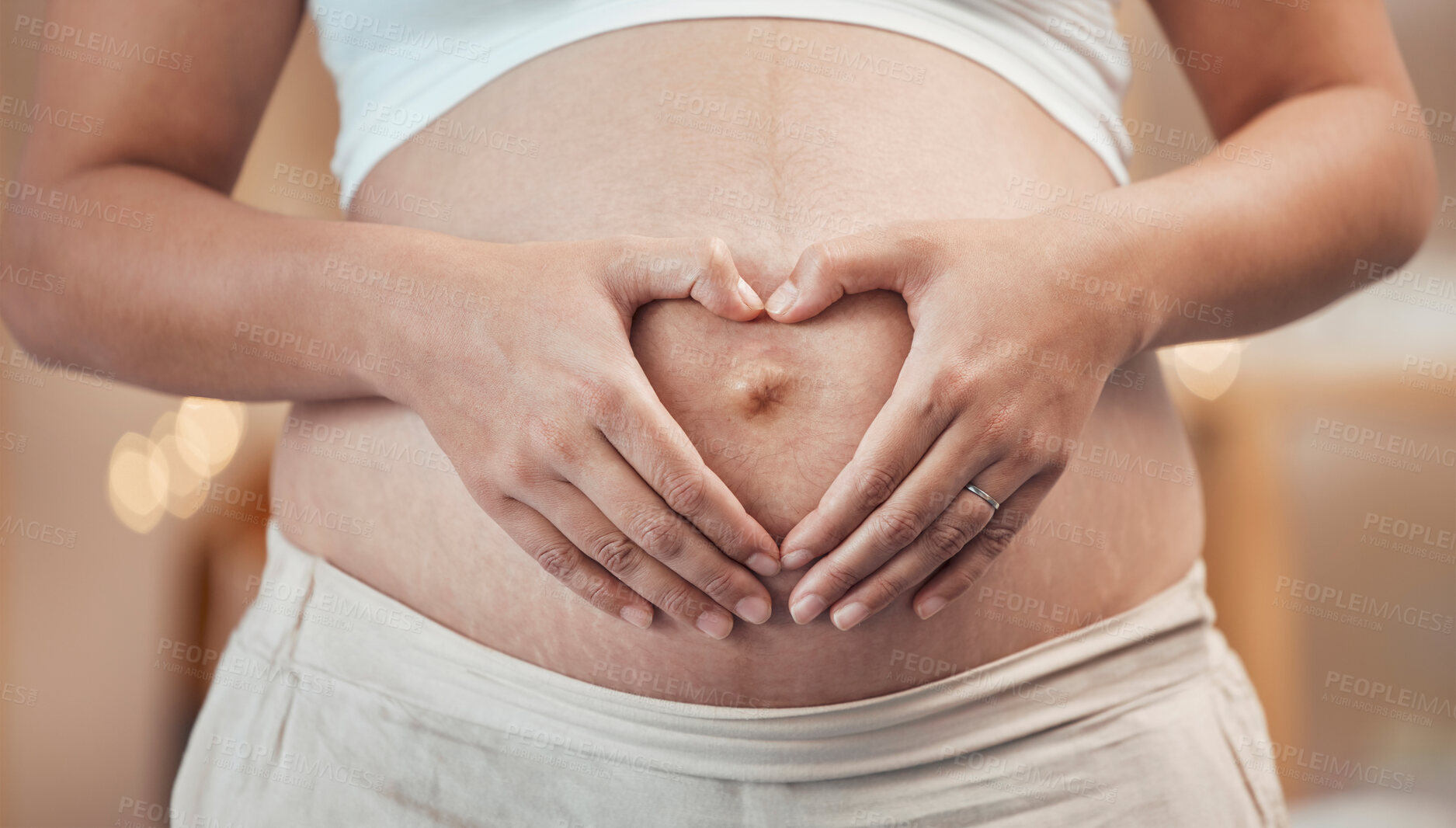 Buy stock photo Woman, hands or heart shape on pregnant stomach in house, home living room or prenatal care clinic. Zoom, pregnancy or mother touching belly in love, care or trust of baby health, support or security