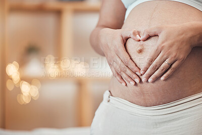 Buy stock photo Pregnancy, love and hands in heart on stomach with woman excited for future family, children and baby. Motherhood, wellness and hand sign of pregnant woman for affection, wellness and childcare