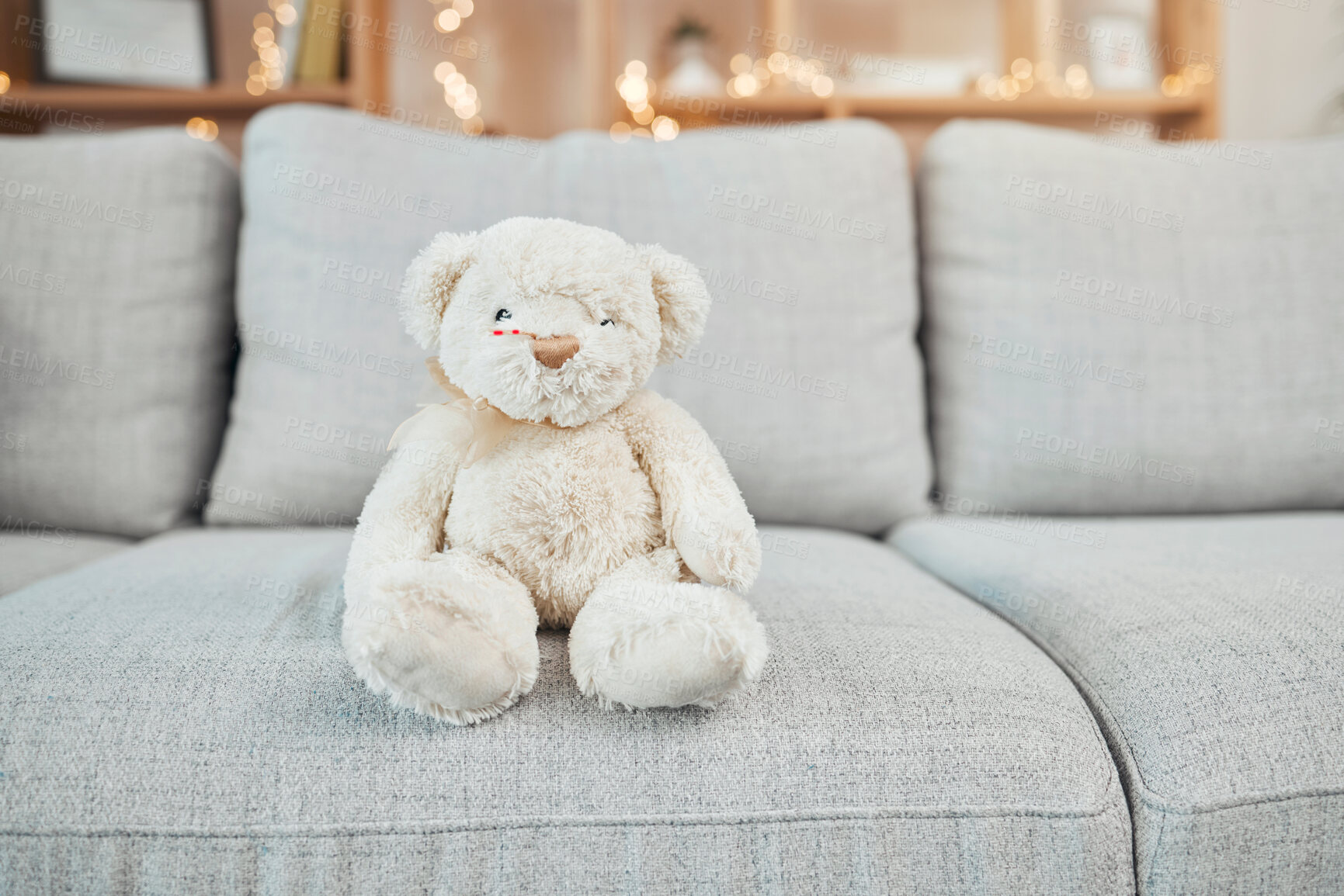 Buy stock photo Teddy bear, child toy and baby toys on a living room sofa for a christmas or birthday present. Soft, furry and children bear on a home lounge couch with no people and holiday gift with bokeh lights