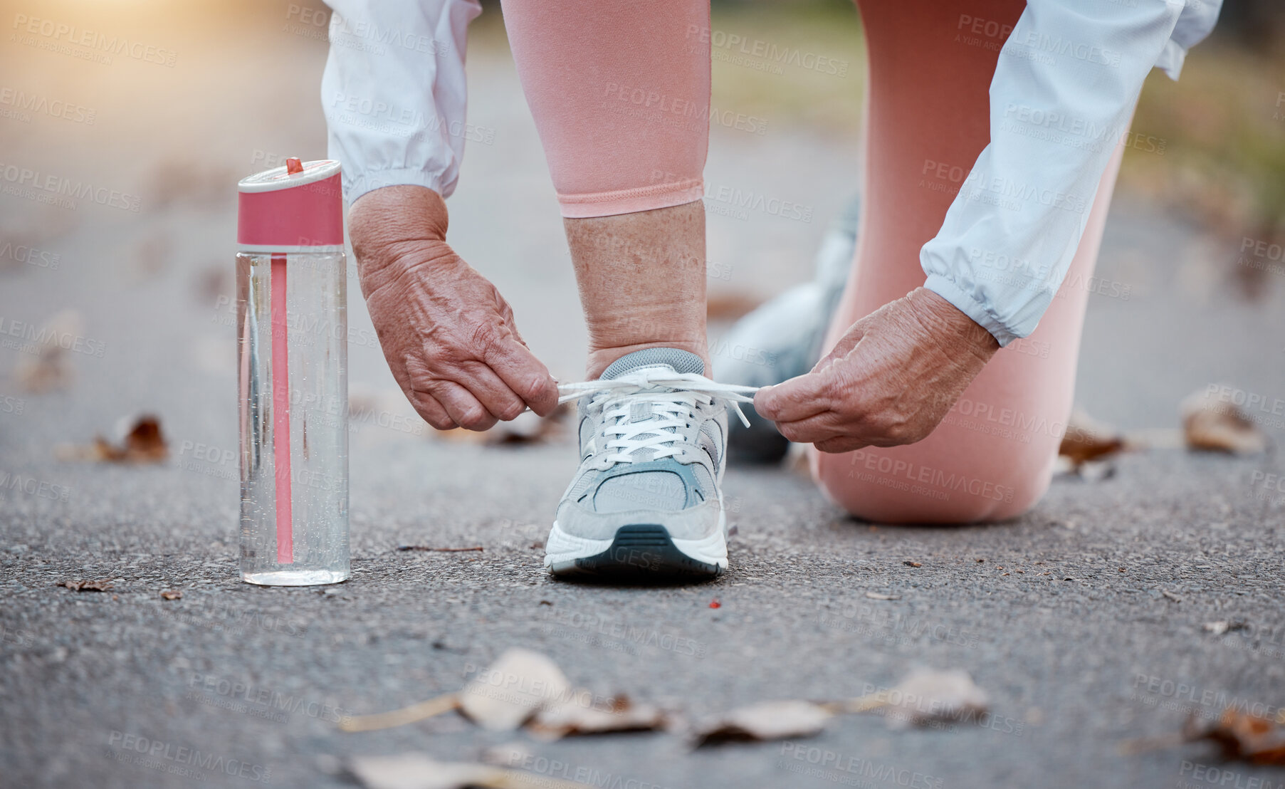 Buy stock photo Senior woman, hand and prepare shoes for running or fitness person in street tie lace for run, cardio or walk. Exercise, training or runner workout of female start outdoor walking for health sport