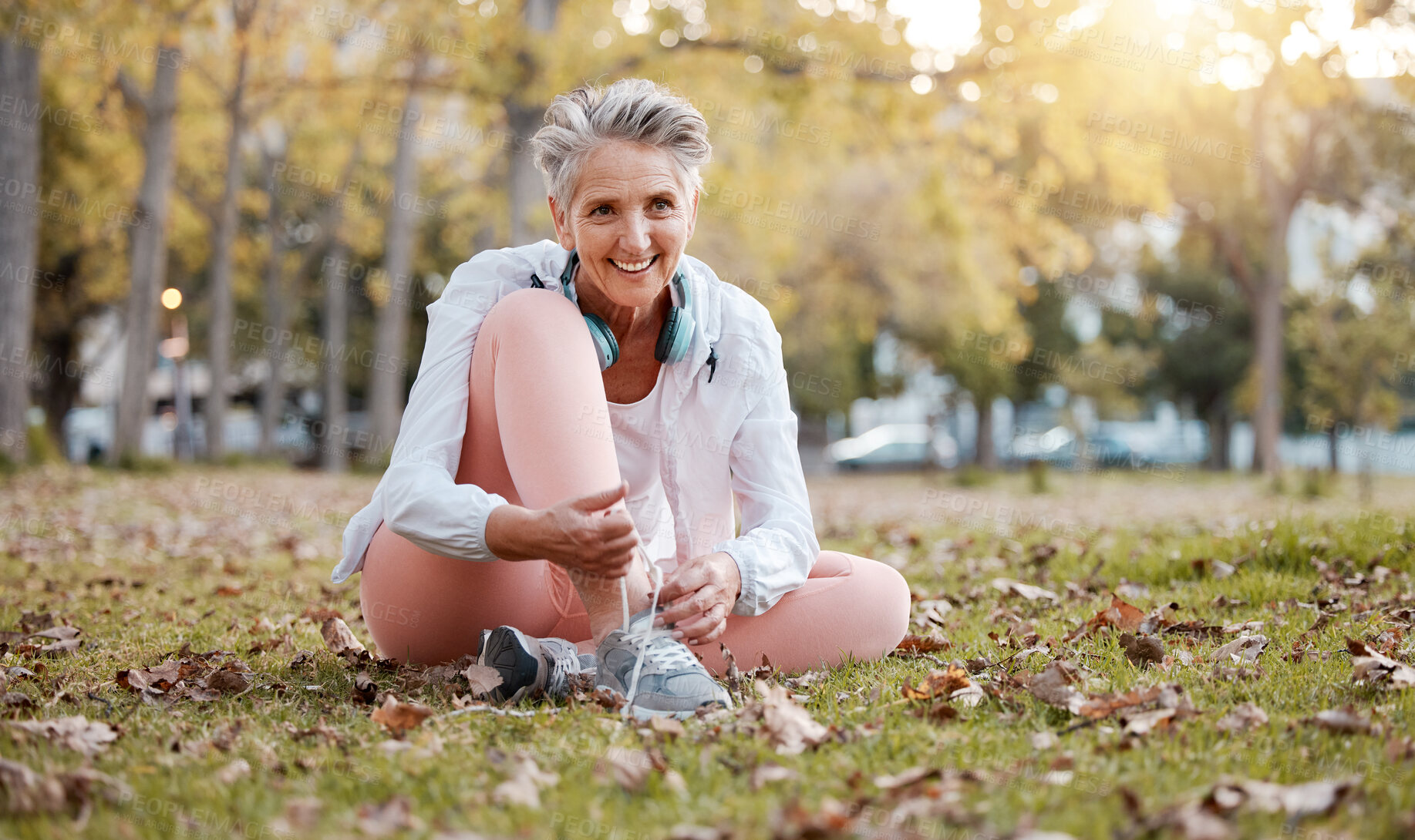 Buy stock photo Fitness, shoes and old woman in park for workout, cardio training or morning running. Happy senior female, fitness and tie sneakers on grass lawn to start exercise, healthy lifestyle or body wellness