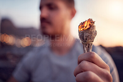 Buy stock photo Man, burning sage and zen meditation outdoor for spiritual health, chakra wellness or to cleanse negative energy. Mindfulness, aromatherapy and male relaxing, meditating outside and performing ritual