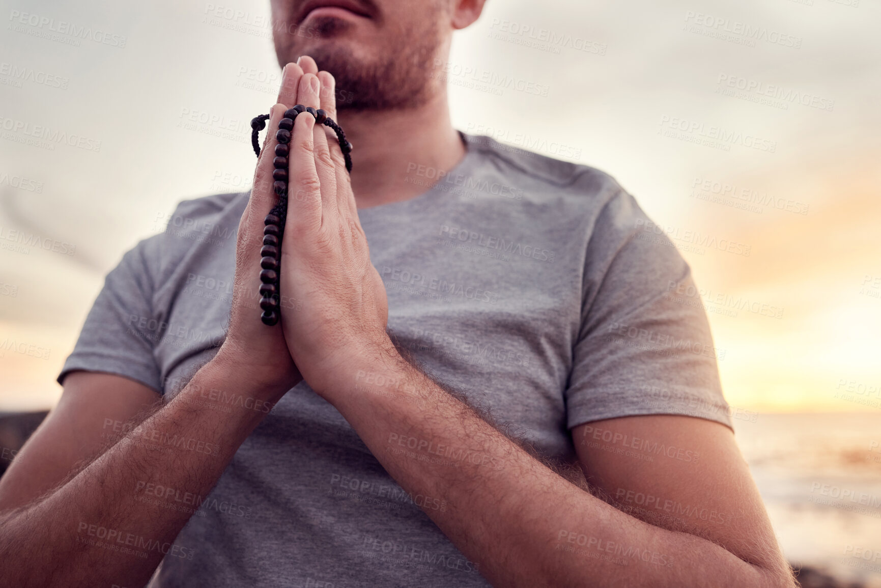 Buy stock photo Spiritual, meditation and hands of a man at the beach, praying for peace and wellness in Indonesia. Yoga, zen and person with a prayer for gratitude, worship and healing in nature at the ocean