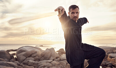 Buy stock photo Man, sword and zen thai chi balance on beach for fitness training, chakra healing or spiritual energy. Thai wellness workout, meditation exercise and therapy with weapon for self defence at ocean