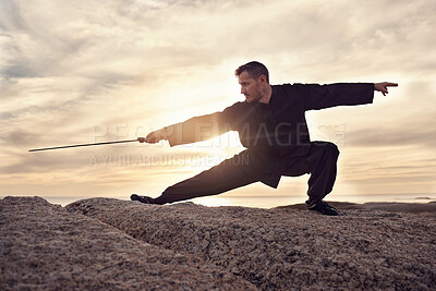 Buy stock photo Martial arts, sword and tai chi, meditation and training at beach, sunset and outdoor in summer in Australia. Man, mindfulness and calm with balance alone in nature, ocean and meditate fo wellness