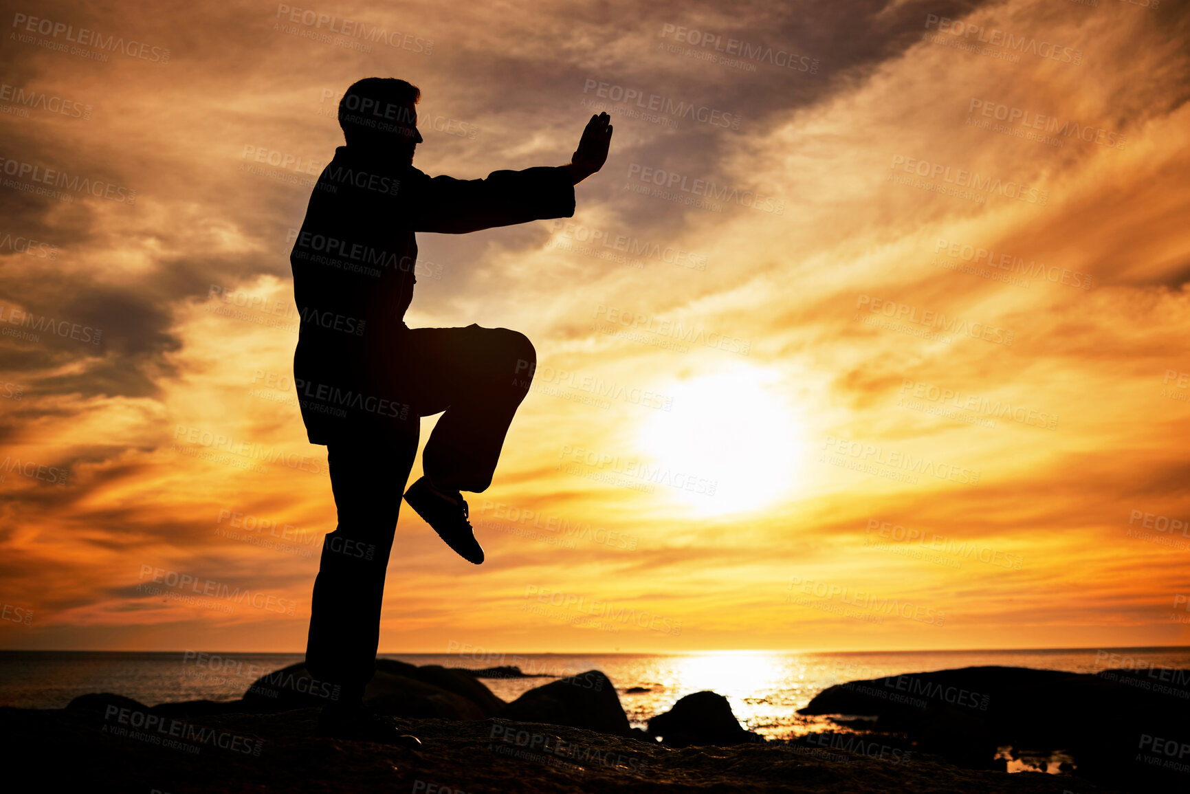 Buy stock photo Karate, sunset and fitness with a sports man training outdoor on the beach during summer with mockup. Exercise, workout and health with the silhouette of a male athlete exercising for balance