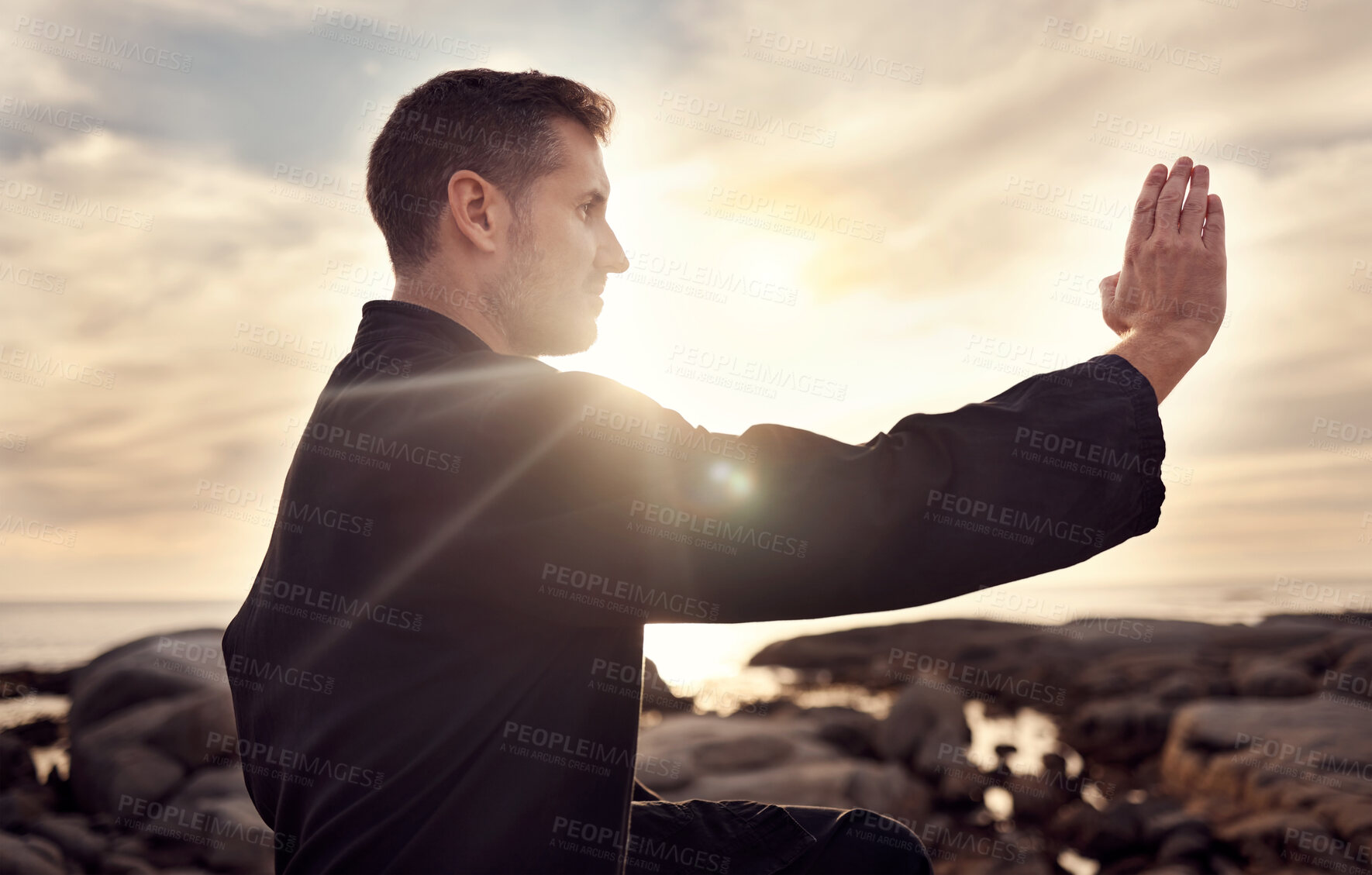 Buy stock photo Karate man, martial arts and tai chi training to fight at beach against cloudy sunset sky for focus, power and energy outdoor. Male fighter ready for sports, fighting and exercise for fitness at sea