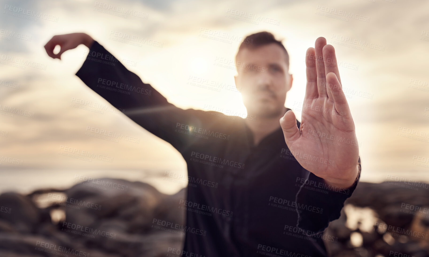 Buy stock photo Fitness, karate or man in nature training his body in a relaxing zen meditation with focus or calm sea energy. Chakra, hands or healthy martial arts expert exercising mindfulness or tai chi balance 