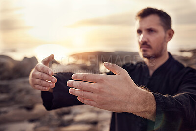 Buy stock photo Man, hands and tai chi on sunset beach in relax workout, fitness or exercise for chakra balance, mental health or mind training. Zoom, sunrise martial arts and zen person by ocean water or nature sea