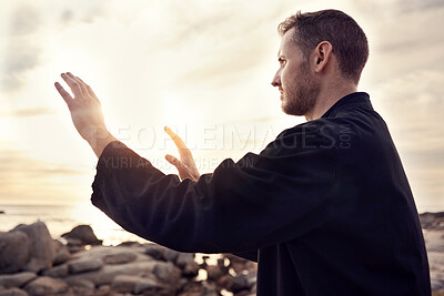 Buy stock photo Meditation, peace and tai chi with man at beach for fitness, spiritual and healing energy. Relax, wellness and health with guy training with breathing exercise for zen, balance and martial arts