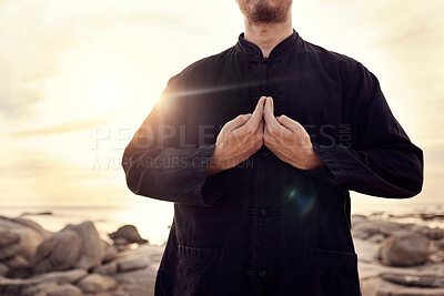 Buy stock photo Tai chi, martial arts and man with hands on beach for fitness and meditation, balance energy and healing at sunrise with self defense exercise. Calm, peace and zen outdoor, karate and wellness.