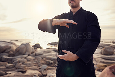 Buy stock photo Health, fitness and tai chi with a man using martial arts for spiritual wellness and exercise by the beach. Fit, strong and asian zen lifestyle with chi gong by the seaside and a male active person