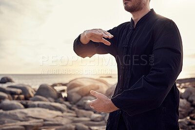 Buy stock photo Beach, peace and tai chi, man in nature for balance and peace for mental wellness or control of body and mind. Spiritual health, fitness and meditation, energy and self care on rocks at sea in sunset