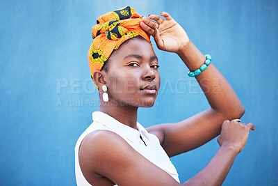 Buy stock photo Black woman, beauty and turban for face of african culture, fashion and freedom on a blue background wall for cosmetics, head scarf and makeup mockup. Portrait of female from Nigeria posing for art