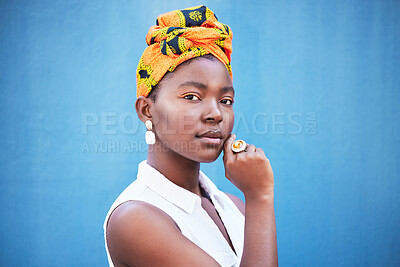 Buy stock photo Portrait, black woman and turban with makeup or relax on blue studio background. Nigerian female, girl or lady with traditional head wrap, natural beauty or cosmetics for smooth, clear skin or mockup