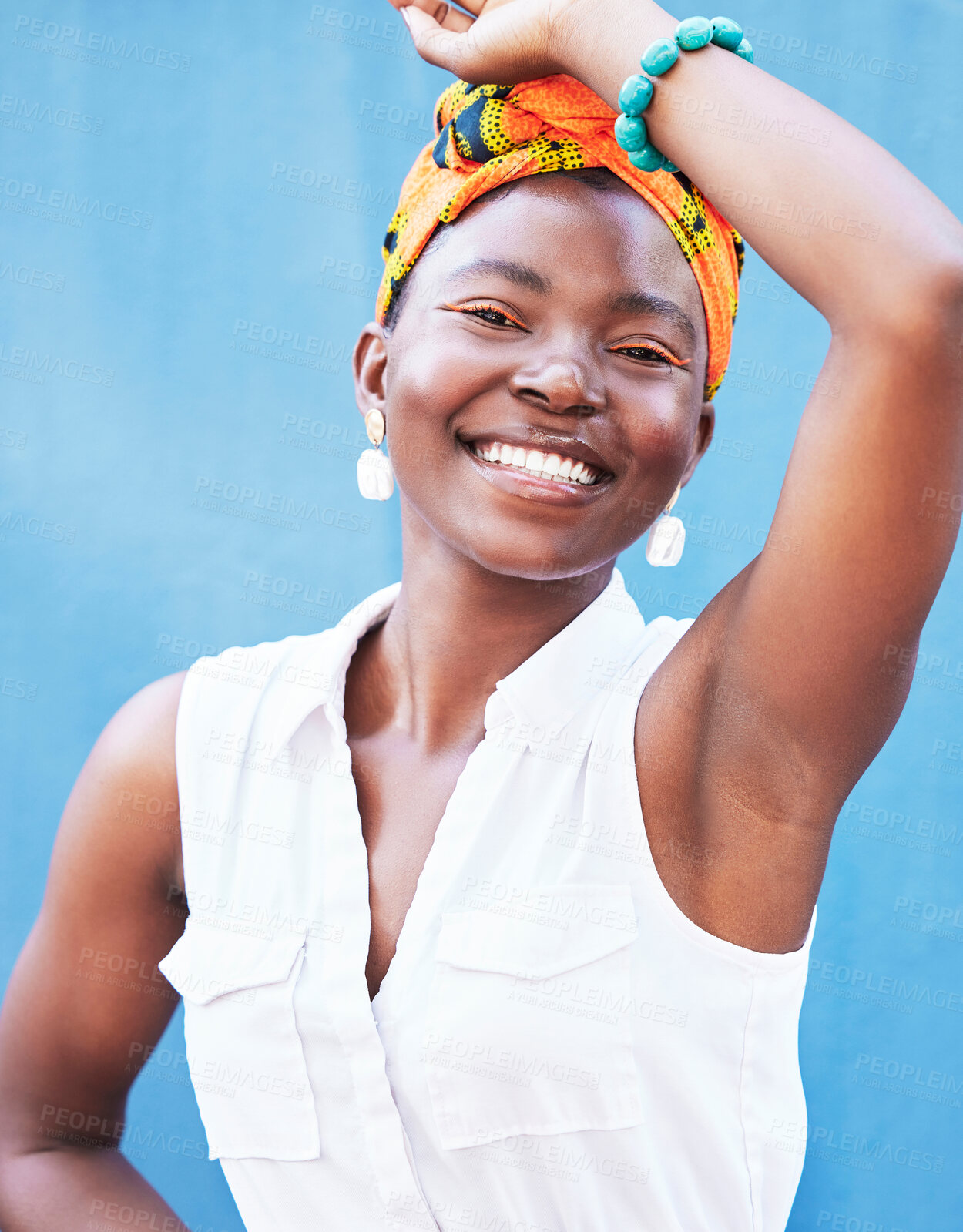 Buy stock photo Fashion, happy glow and face of a black woman advertising jewelry, clothes and makeup against a blue background in studio. Color, marketing cosmetics and portrait of an African girl with happiness