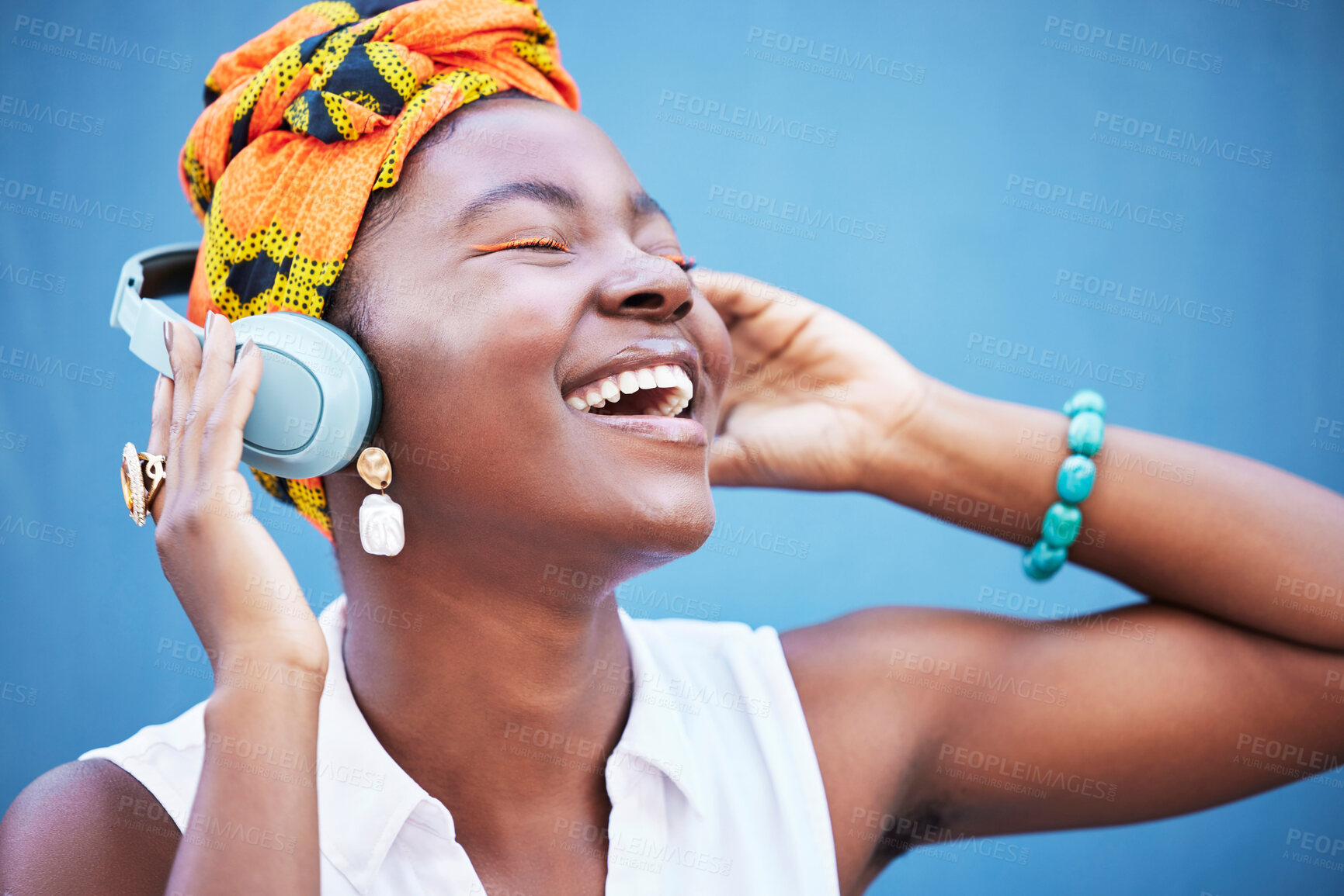 Buy stock photo Black woman, headphones and happy or smile for podcast, audio motivation or streaming music online in blue studio background. African woman, happiness and lifestyle culture or relax with headset