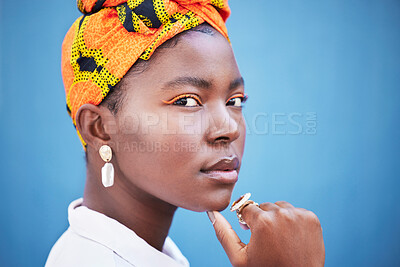 Buy stock photo African, fashion and portrait of black woman on blue background with head scarf, glowing skin and makeup. Beauty, glamour and face of female model with exotic style, jewellery and cosmetics in studio