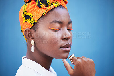 Buy stock photo Cosmetics, skincare and black woman with head wrap, natural beauty and wellness against a blue studio background. Jamaican female, girl and makeup for eyelash color, traditional headscarf and mockup.