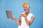 Laptop success, email and happy black woman with communication, online work and pointing at internet on blue background in studio. Computer, digital business and worker impressed with web networking