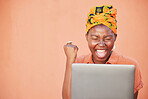 Success, celebration and black woman on laptop after winning on an orange studio background mock up. Face, winner and female on computer after online lottery win or reading good news on social media.