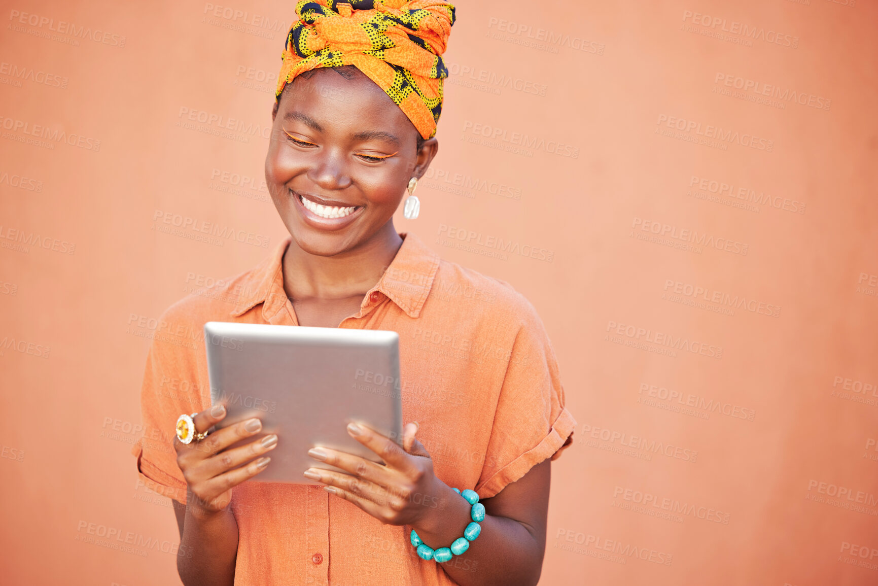 Buy stock photo Face, tablet and black woman on social media in studio on an orange mockup background. Tech, smile and happy female from Nigeria streaming video, movie or internet browsing on digital touchscreen.