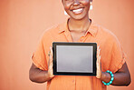 Happy, girl and hands with tablet app mockup for marketing with optimistic smile holding touchscreen. Digital, advertising and empty tech screen of black woman at orange wall background.