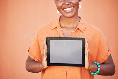 Buy stock photo Happy, girl and hands with tablet app mockup for marketing with optimistic smile holding touchscreen. Digital, advertising and empty tech screen of black woman at orange wall background.