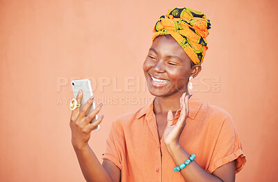 Buy stock photo Black woman, phone and video call, wave and communication outdoor against peach wall outdoor. Gen z girl, fashion and virtual conversation, video conference and happy smile or talking with smartphone